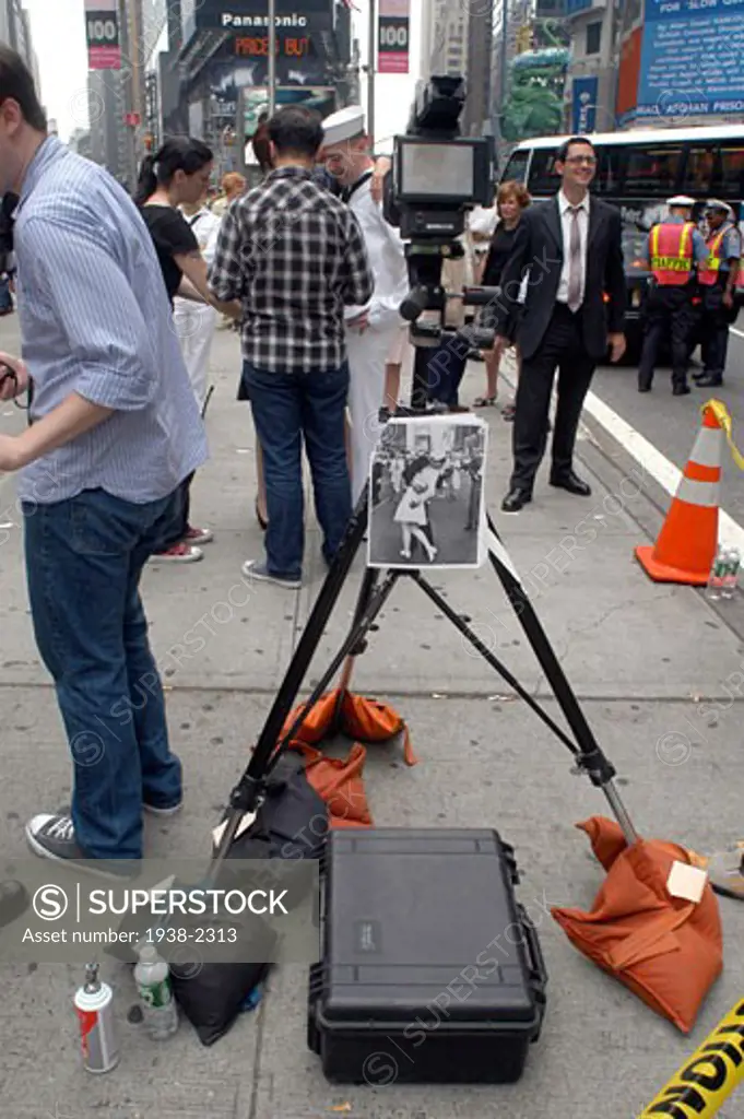 Commercial photo session in Times Square  NYC  recreating the famous picture where a man kisses goodbye a woman   changing the roles  in Manhattan  New York City