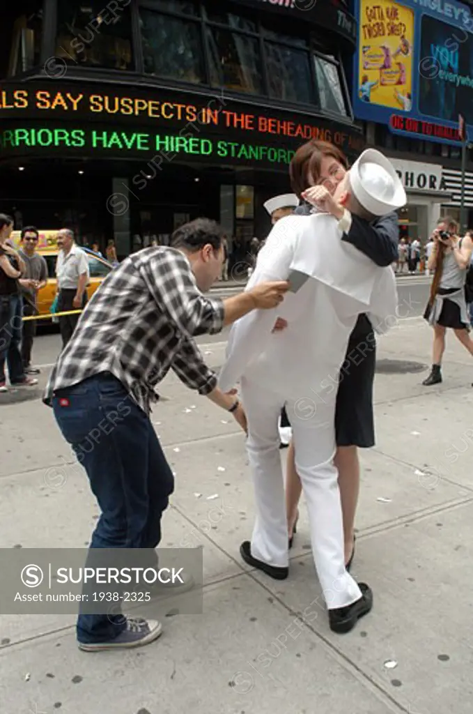 Commercial photo session in Times Square  NYC  recreating the famous picture where a man kisses goodbye a woman   changing the roles  in Manhattan  New York City