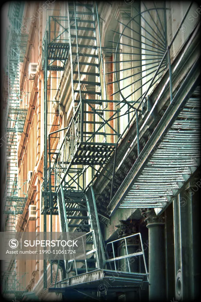 Iron fire escape stairs and balconys on the facade of a building in SoHo RE of New York City