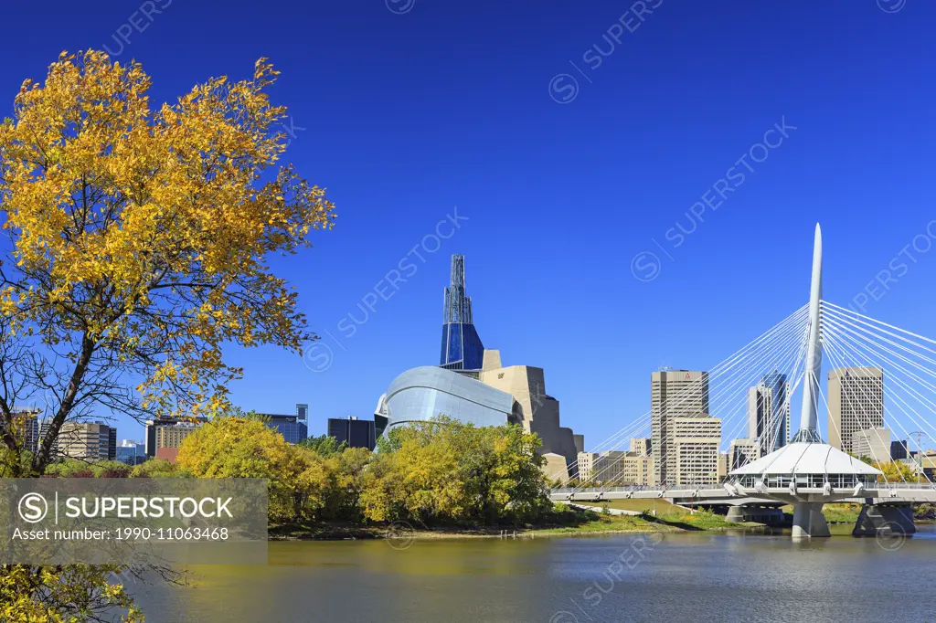 Winnipeg skyline viewed from the Red River, with Canadian Museum for Human Rights and Esplanade Riel Bridge, autumn, Winnipeg, Manitoba, Canada