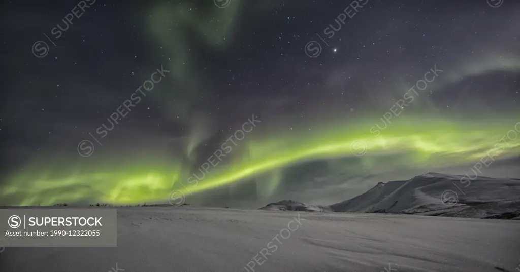 Northern lights or aurora borealis above the snow covered tundra along the Dempster Highway, Yukon.