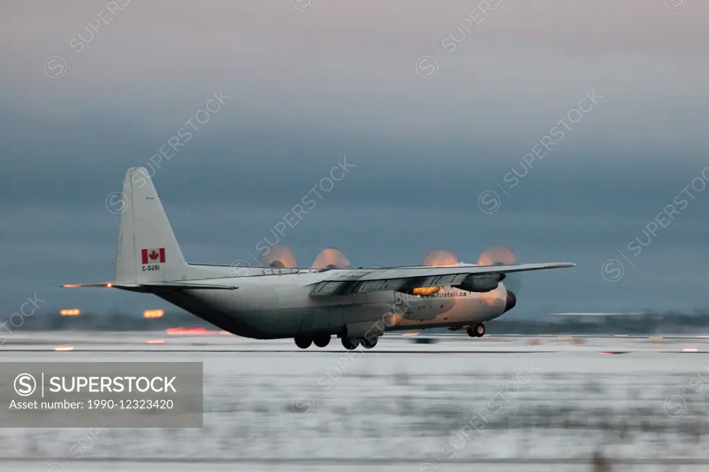 A First Air Hercules cargo plane lands at dusk in Yellowknife, Northwest Territories, Canada