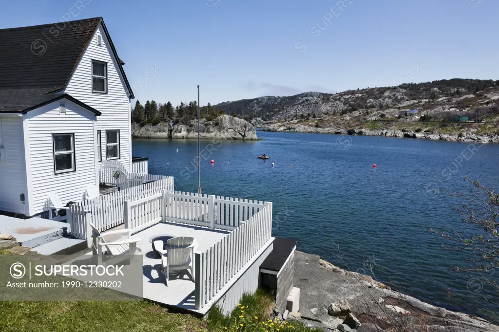 White house with deck on the edge of Brigus Cove, Brigus, Newfoundland, Canada