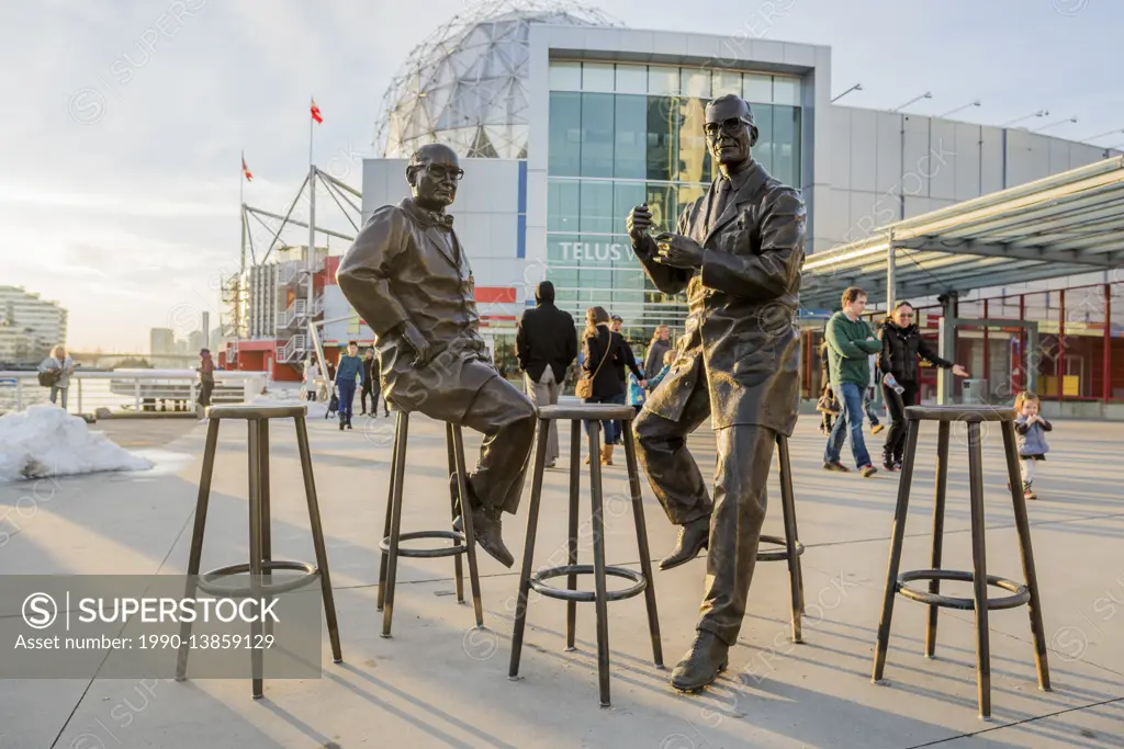 Bronze sculptures of doctors James Till and Ernest McCulloch in front of Science World, Vancouver, British Columbia, Canada.