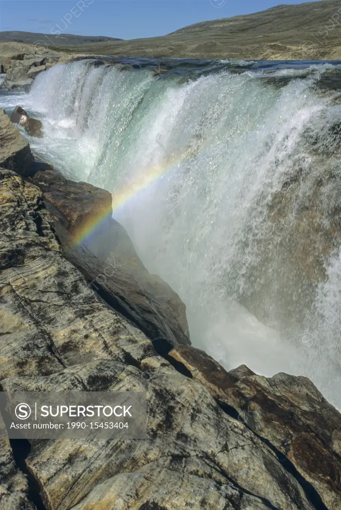 Waterfall and rainbow on river emptying into western end of Wager Bay, Ukkusiksalik National Park, Nunavut, Canada