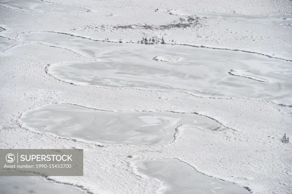 Hudson Bay coastline at freeze-up from the air- Frozen ponds with a light skiff of snow