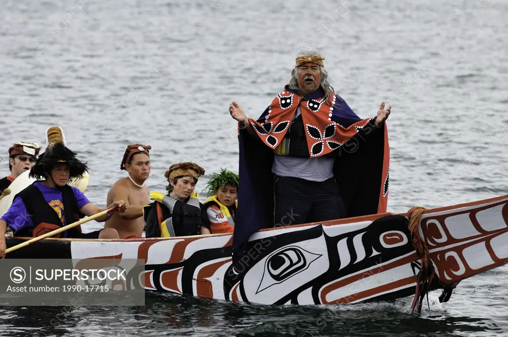 Native man standing at bow of canoe during Tribal Journeys event at the North American Indigenous Games in Duncan.