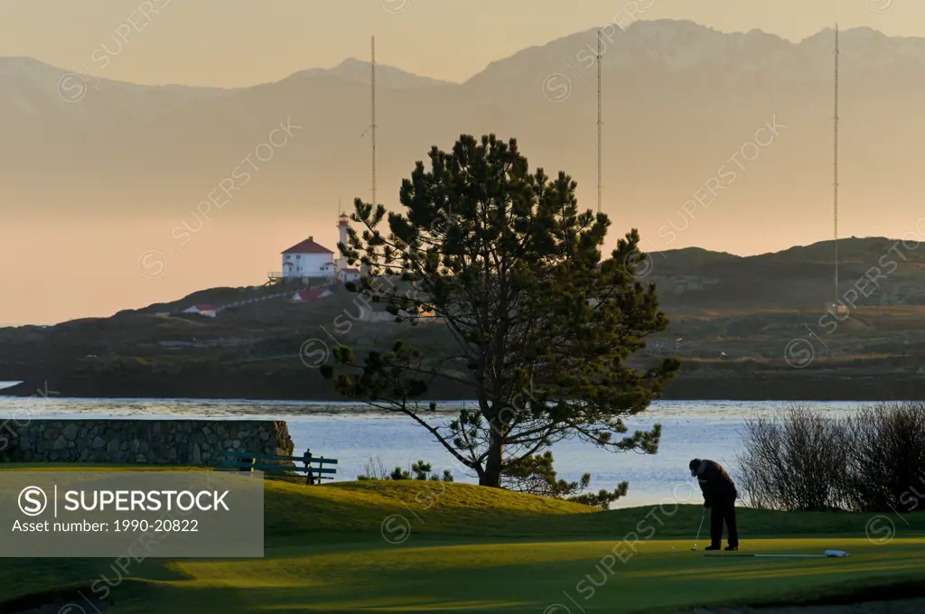 The Olympic Mountains and the Trial Island Light provide a dramatic backdrop for the Victoria Golf Club in Victoria BC.