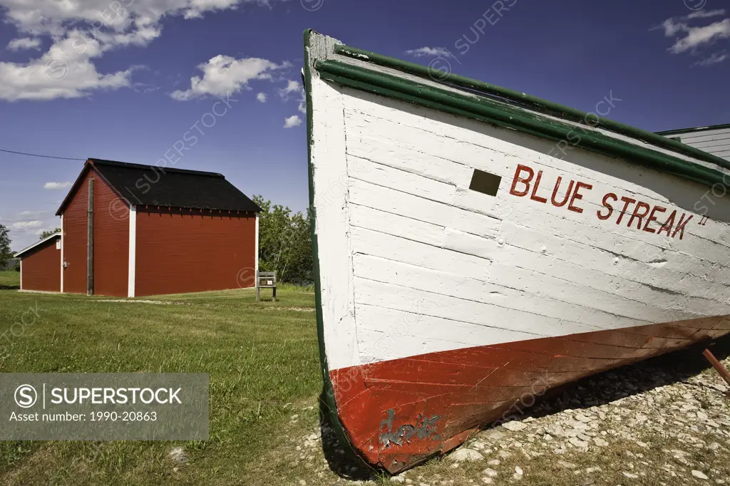 Ice house and old wooden fishing boat in the Icelandic settlement of Hecla Village. Hecla Island Provincial Park, Manitoba, Canada.