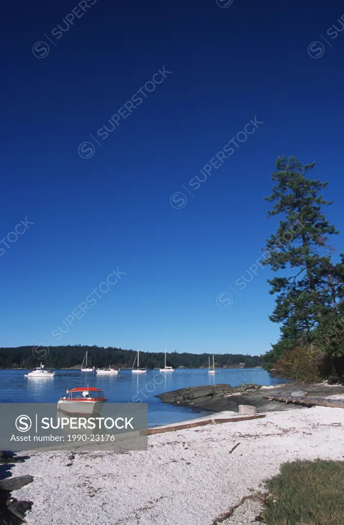 Shell beach with boat, Russell Island , Gulf Islands National Park, near Saltspring, British Columbia, Canada