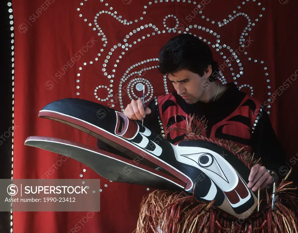 kwakwaka´wakw artisan paints ceremonial mask, Vancouver Island, British Columbia, Canada