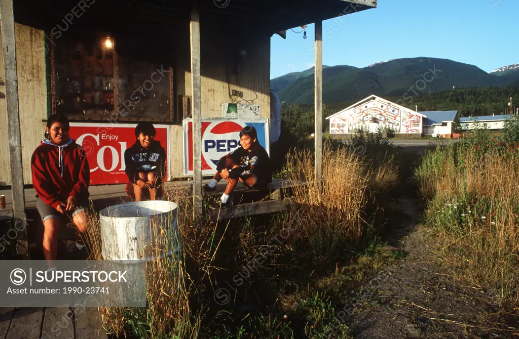 Nass River Valley, school girls on storefront porch in New Aiyanch, British Columbia, Canada