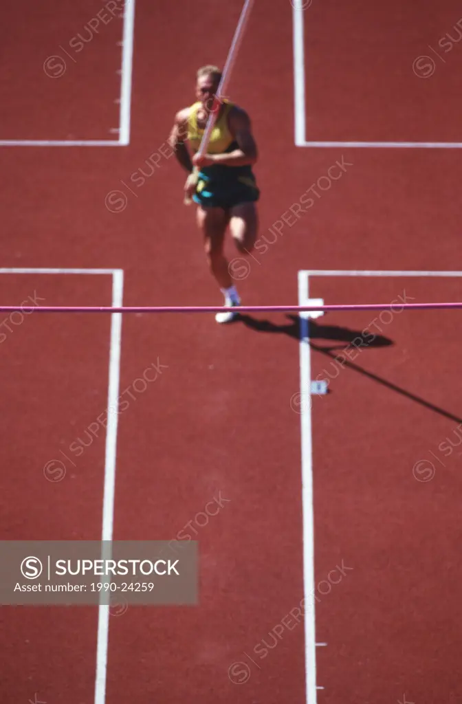 Track and field competition, pole vaulter on rust coloured track, British Columbia, Canada