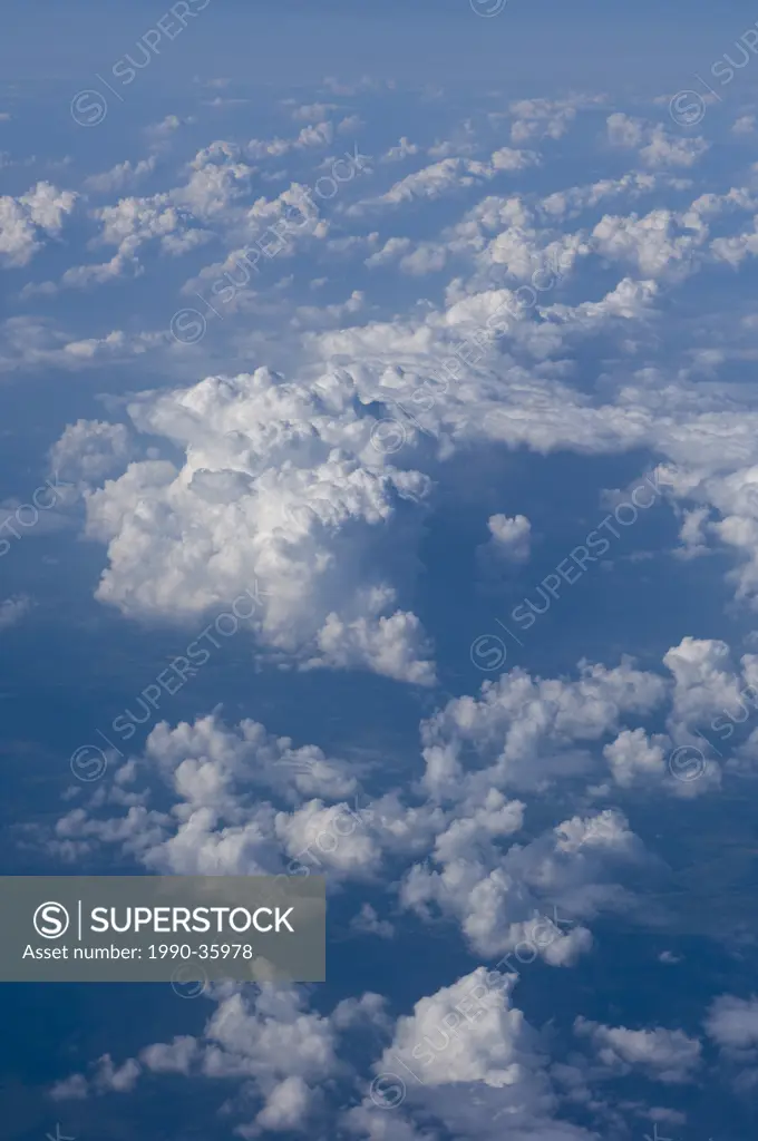 Cumulus and cumulonimbus clouds from aircraft window