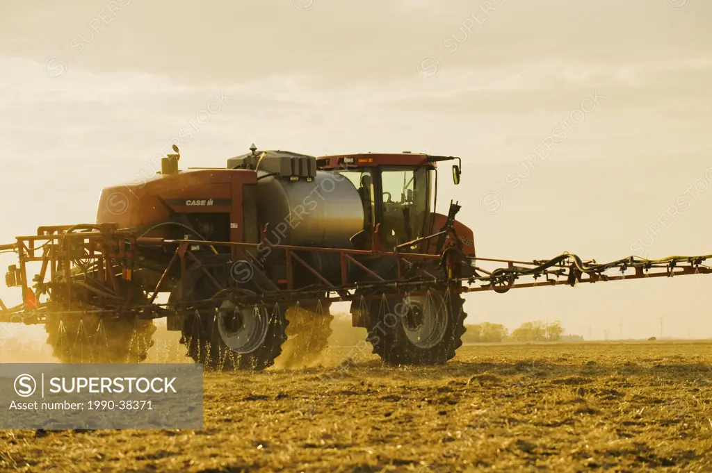 a high clearance sprayer applies liquid fertilizer on a newly seeded field, near Dugald, Manitoba, Canada