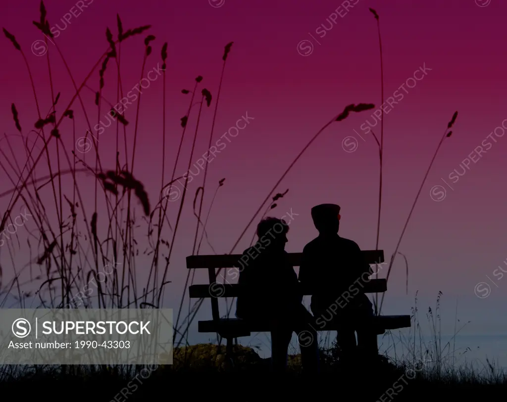 An elderly couple in silhouette profile on a park bench.