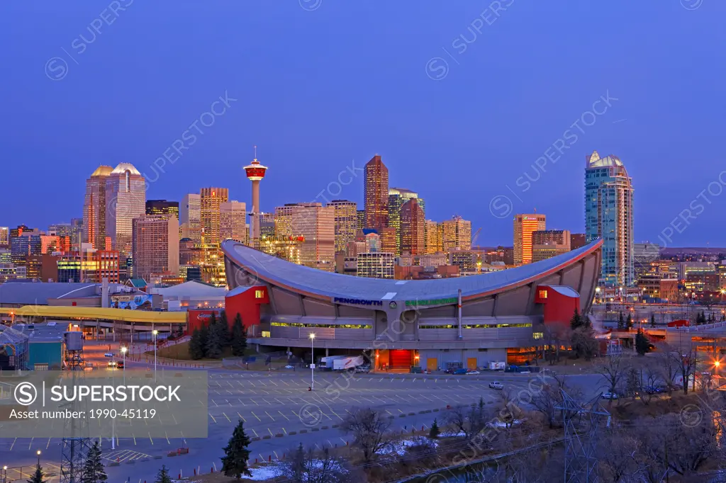 The Saddledome with high_rise buildings and the Calgary Tower in the background at sunrise, City of Calgary, Alberta, Canada.