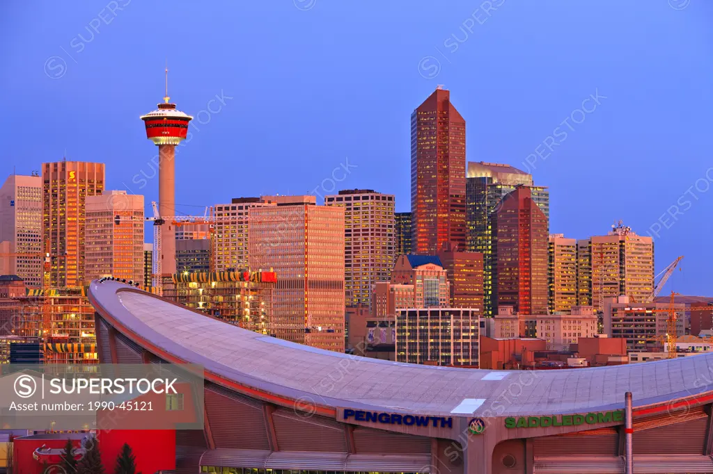 The Saddledome with high_rise buildings and the Calgary Tower in the background at sunrise, City of Calgary, Alberta, Canada.