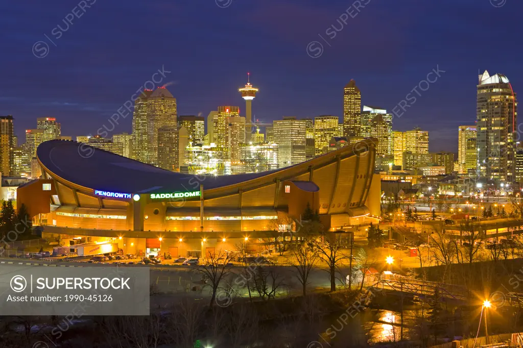 The Saddledome with high_rise buildings and the Calgary Tower in the background at dusk, City of Calgary, Alberta, Canada.