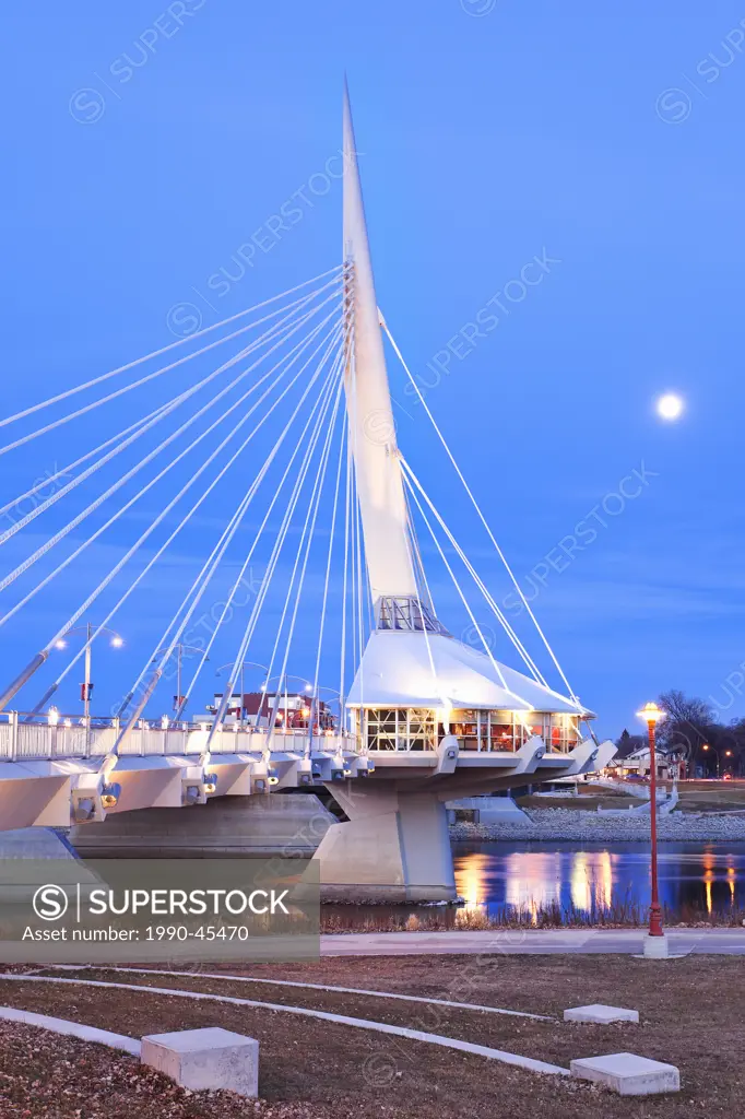 Esplanade Riel Pedestrian Bridge spanning the Red River, on a moonlit night. Winnipeg, Manitoba, Canada.