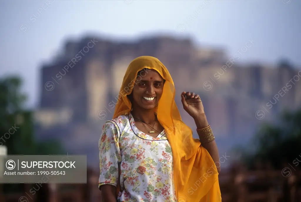 A Rajasthani woman poses in front of Kumbhalgarh Fort in Udaipur, India.