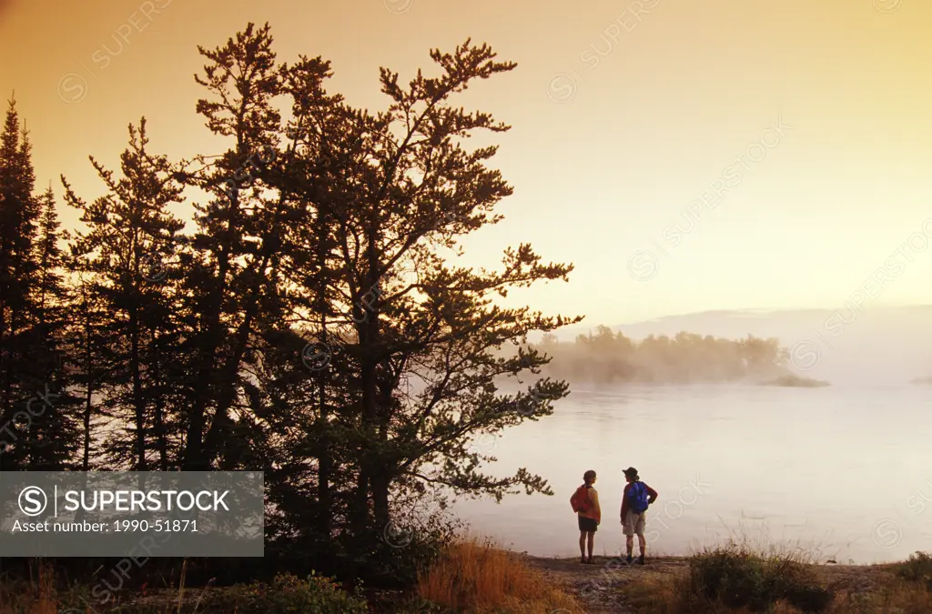 Hikers along the Winnipeg River, near Pinawa, Manitoba, Canada.