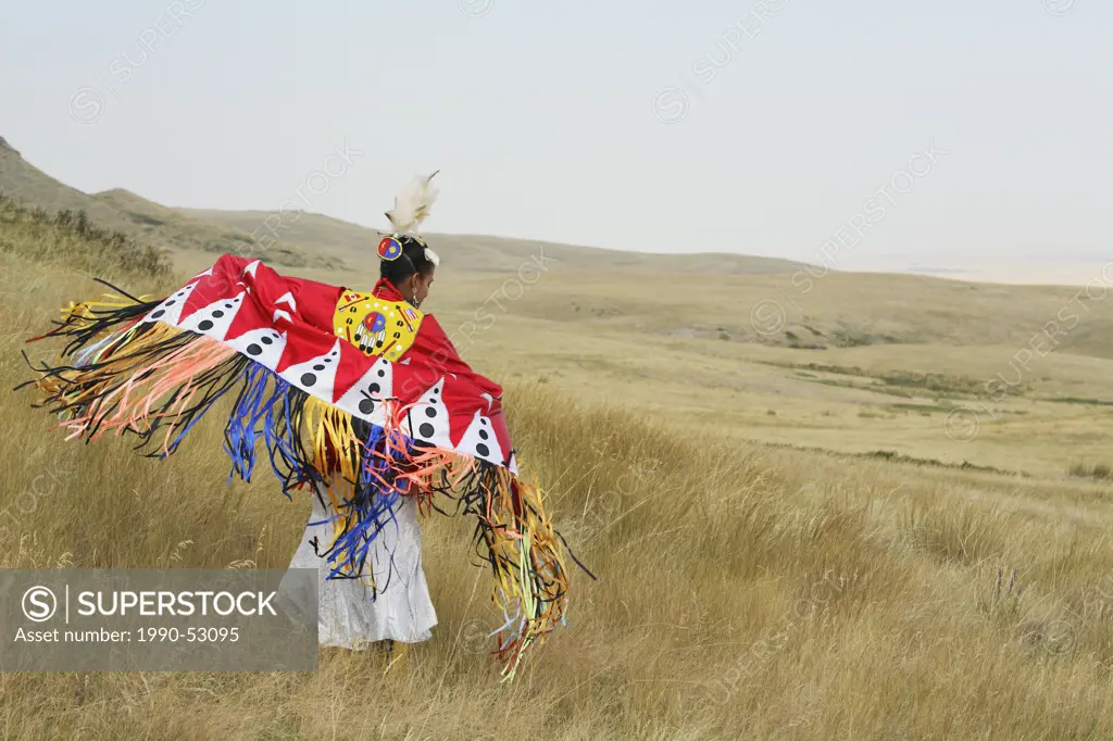 Blackfoot Piikani woman Fancy Shawl dancing on the Canadian prairies at Head Smashed In Buffalo Jump