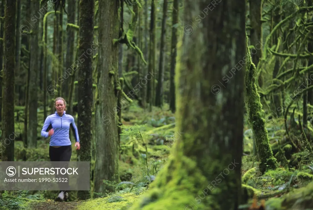 Women trail running in Golden Ears Provincial Park, British Columbia, Canada.