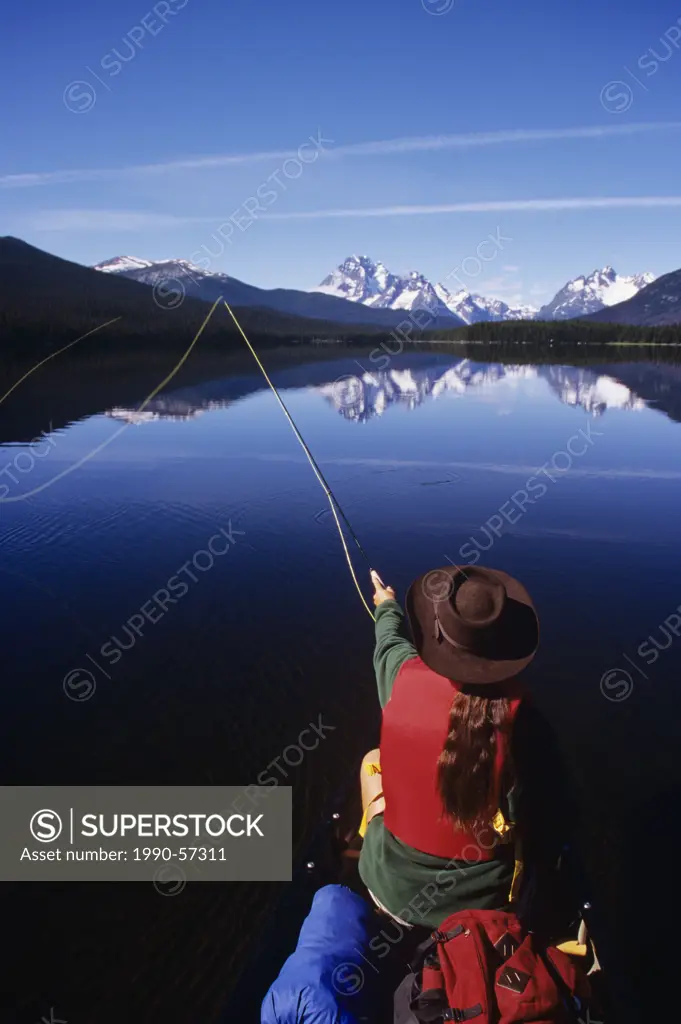 Fishing from canoe on Turner Lakes, Tweedsmuir Park, Chilcotin region, British Columbia, Canada.