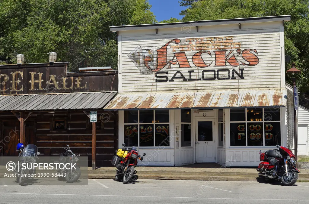 Motorcycles have replaced horses outside Three Fingered Jacks Saloon, Winthrop, Washington, the oldest legal Saloon in Washington State, United States...