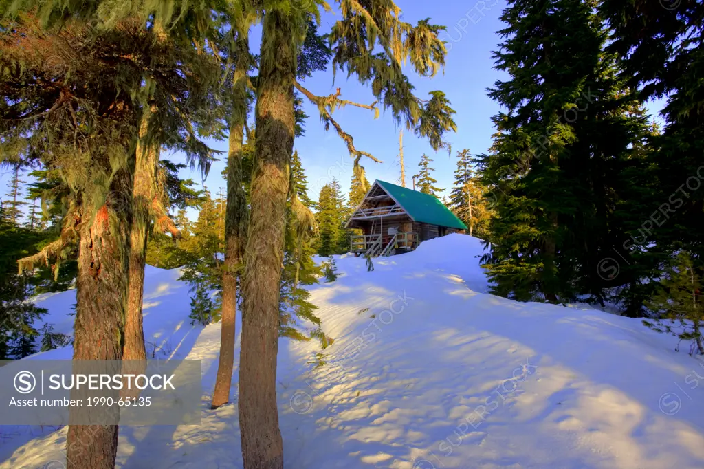 The morning sun illuminates Edwards Lake Cabin in Tetrahedron Provincial Park on the Sunshine Coast of British Columbia, Canada. No Property Release.