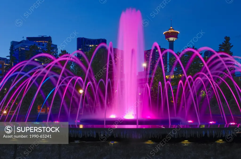 Illuminated fountain with the Calgary Tower in the distance, Central Memorial Park, Calgary´s oldest park Calgary, Alberta, Canada