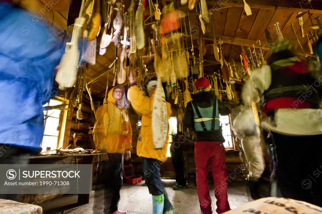 Old cabin with carved canoe paddles from previous expeditions hang from rafters (also called 'The Paddle Cabin at Prairie Creek), Nahanni River, Nahan...