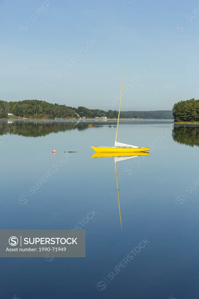 Sailboat reflected in LaHave River, Little Island, Nova Scotia, Canada