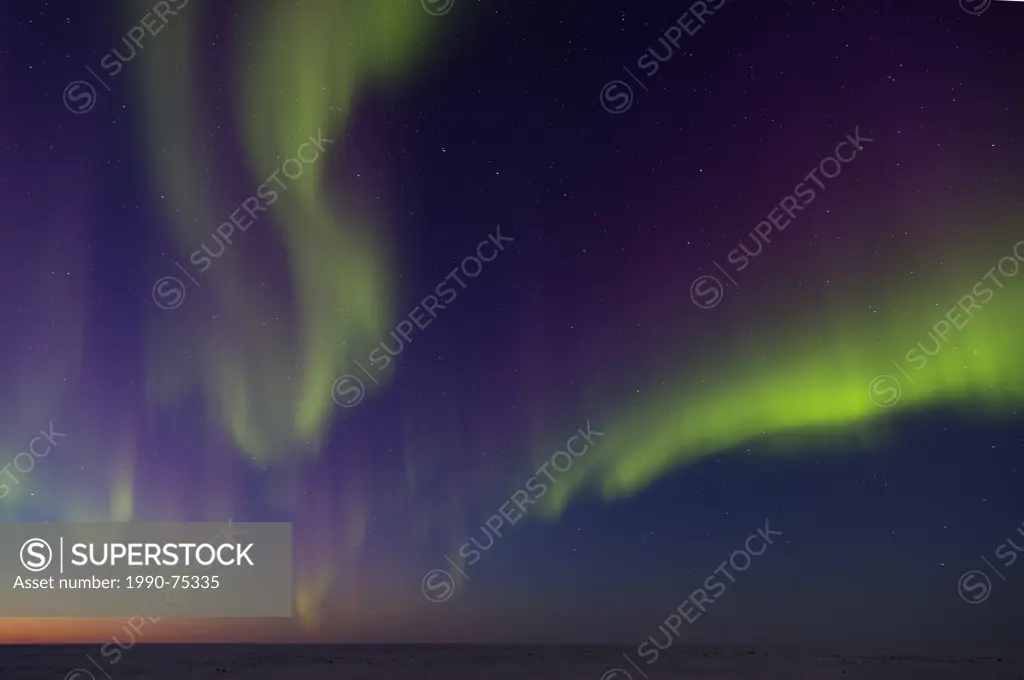 Northern lights (Aurora borealis) over tundra, west coast Hudson Bay, south of Arviat, Nunavut, Canada