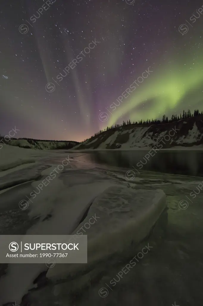 Aurora borealis or northern lights over the Yukon River, Yukon.