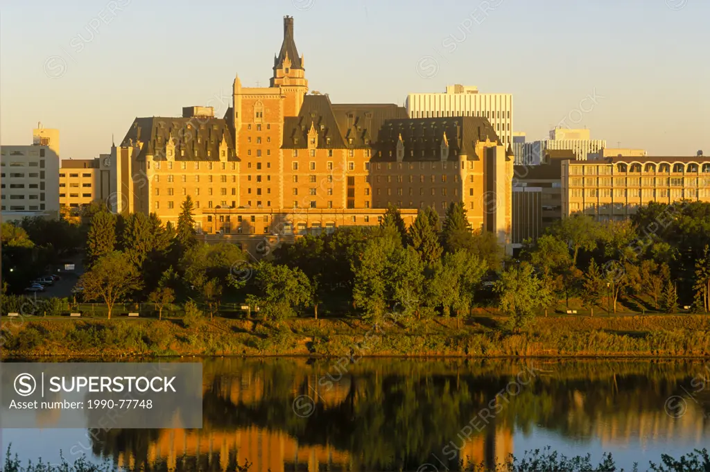 The Delta Bessborough hotel reflected in the South Saskatchewan River at sunrise, Saskatoon, Saskatchewan, Canada