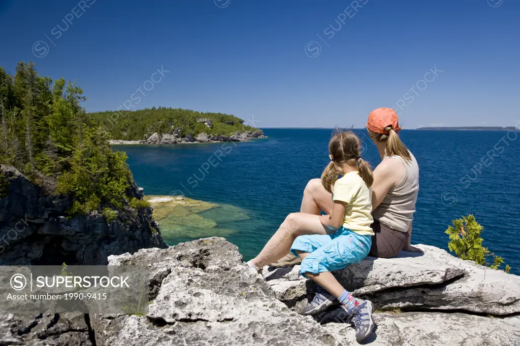 Young mother and daughter enjoy view at The Grotto along Bruce Trail, Bruce Penninsula National Park, near Tobermory, Ontario, Canada.