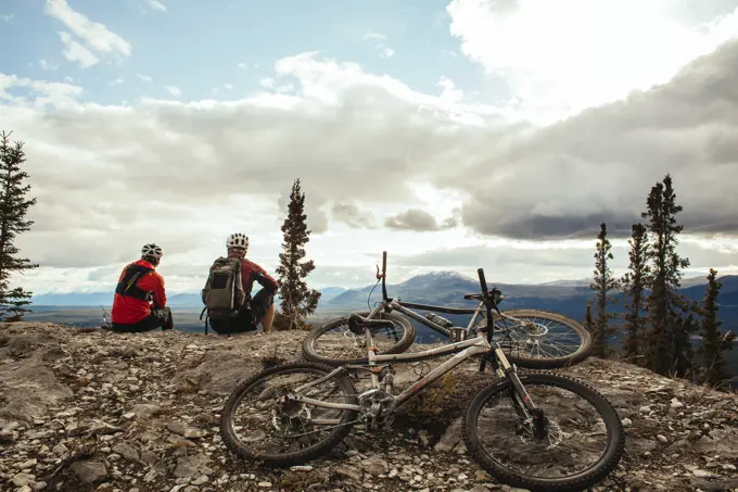 Two mountain bikers enjoying the fall colors and trails in Whitehorse, Yukon