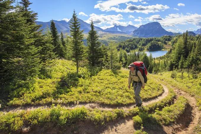 A back packer ascends the Citadel Pass trail above Howard Douglas Lake in Banff National Park, Alberta, Canada. Model Released.