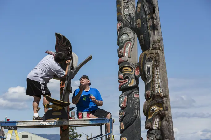 Two first nations family members refurbish a relatives memorial pole, Campbell River