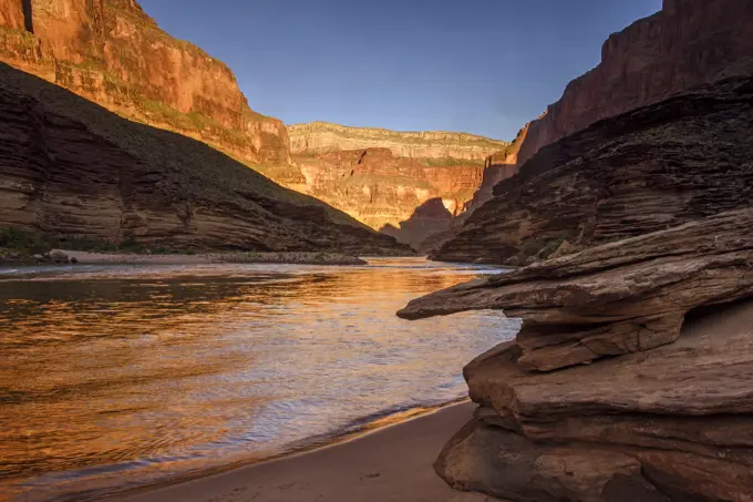 Dawn light reflecting off the Grand canyon walls into the Colorado River from Conquistador Isle (Mile 121), Grand Canyon National Park, Arizona, USA