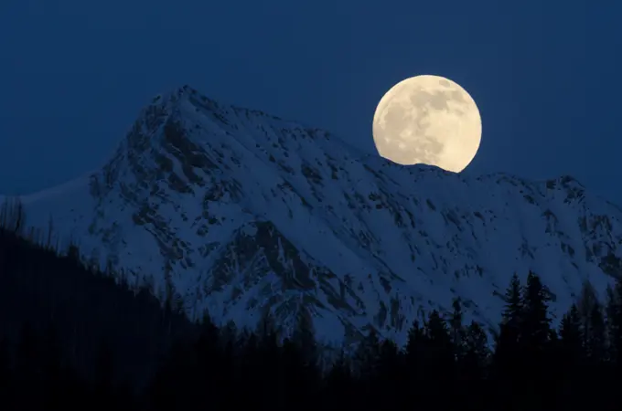 Full moon over the Canadian Rockies near Canal Flats, British Columbia