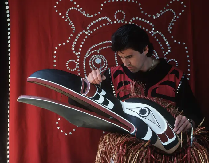 kwakwaka´wakw artisan paints ceremonial mask, Vancouver Island, British Columbia, Canada