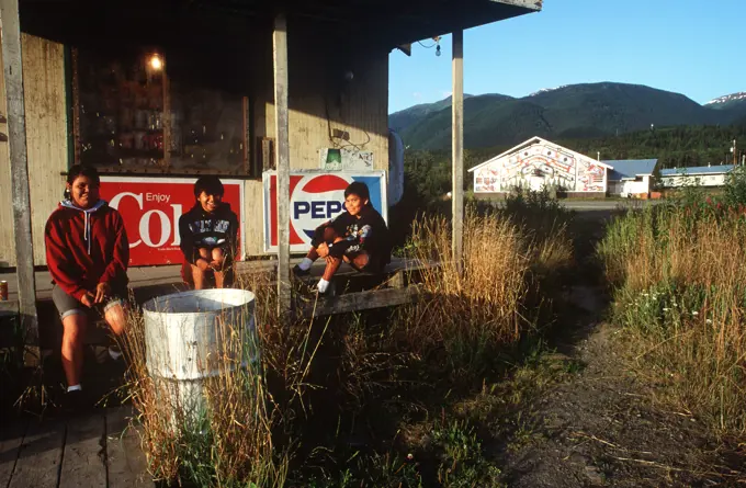 Nass River Valley, school girls on storefront porch in New Aiyanch, British Columbia, Canada