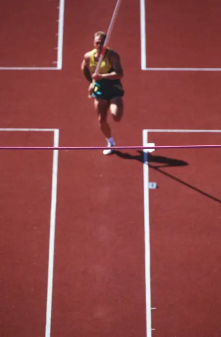 Track and field competition, pole vaulter on rust coloured track, British Columbia, Canada