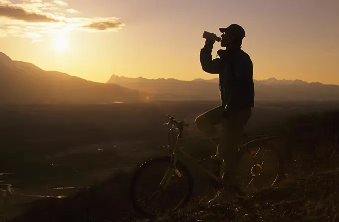 Mountain biker at sunset, Bulkley Valley, British Columbia, Canada