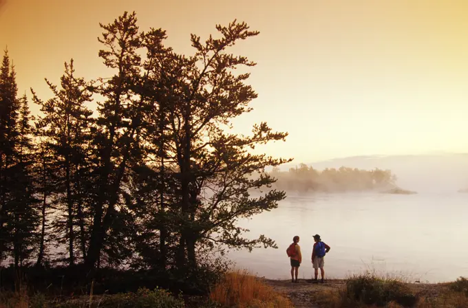 Hikers along the Winnipeg River, near Pinawa, Manitoba, Canada.