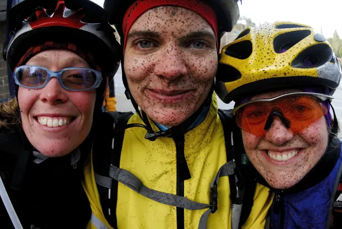 Three young women with muddy faces after mountain biking, Sunshine Coast trails. Gibsons, British Columbia, Canada.