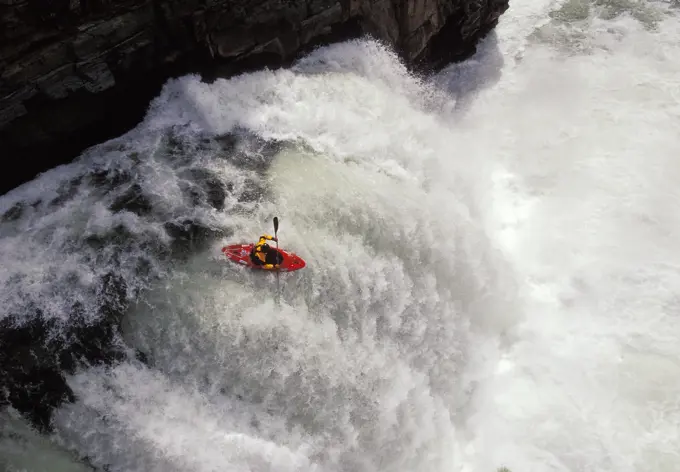 Kayaker running ´Leap Of Faith´ waterfall on Elk River near Fernie in East Kootenays, British Columbia, Canada.